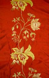 Closeup of embroidered side border of this silk fabric for draperies