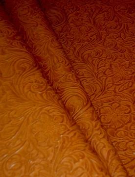 Draped image of Faux Tooled Etched Leather by the yard pattern Laredo Upholstery Vinyl Fabric Color Pottery