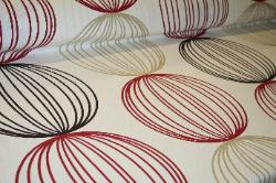 Prestigious Textiles Pattern Orbital Color Ruby Interior Decorating Fabric Angle View of this Discounted Home Decor fabric at Schindler's Upholstery Shop